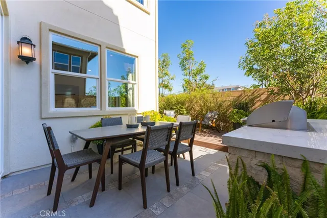 a view of an outside dining space with a table and chairs