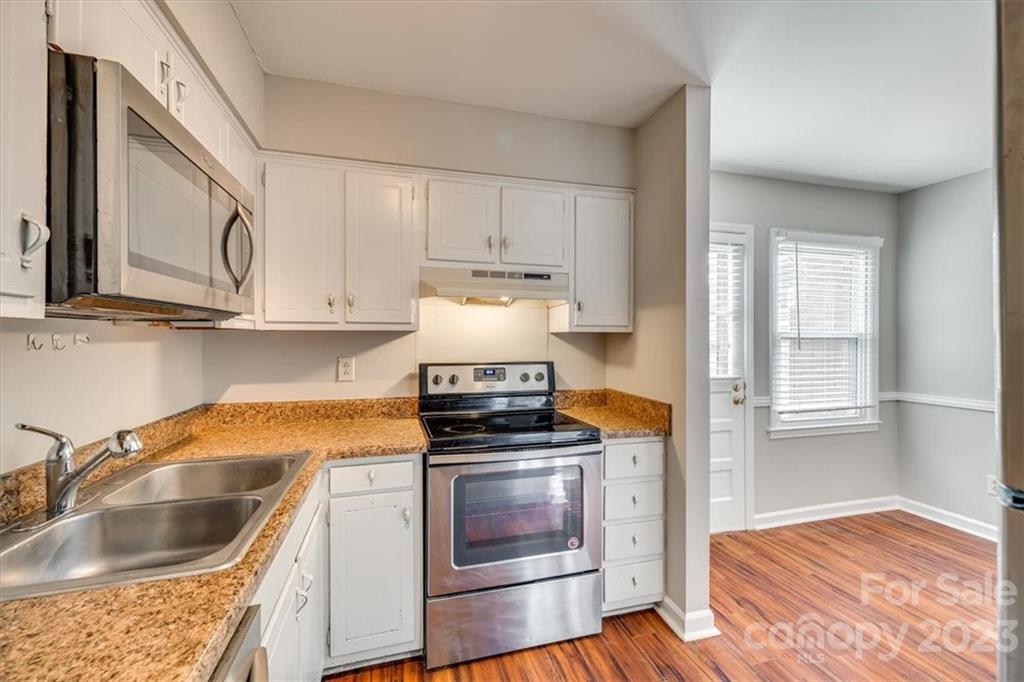 3722 Park Road, Unit I Charlotte, NC 28209 - Photo 13 of 27 a kitchen with granite countertop a sink cabinets and stainless steel appliances