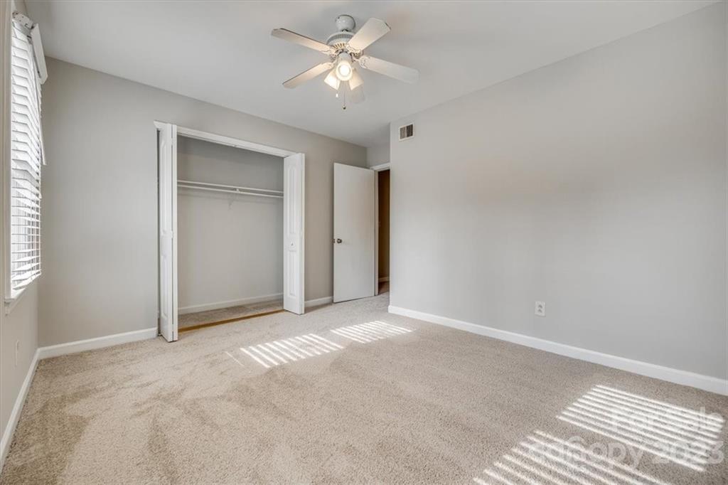3722 Park Road, Unit I Charlotte, NC 28209 - Photo 19 of 27 a view of an empty room and a ceiling fan