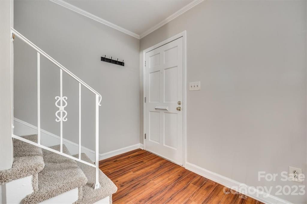 3722 Park Road, Unit I Charlotte, NC 28209 - Photo 3 of 27 a view of an empty room with wooden floor and a window