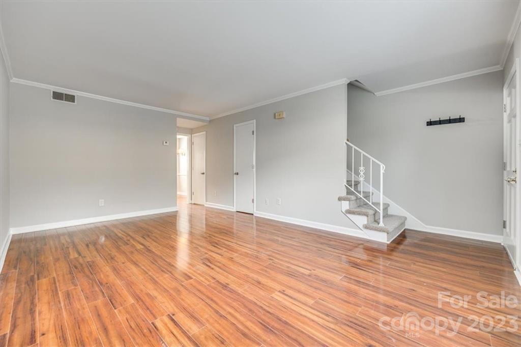 3722 Park Road, Unit I Charlotte, NC 28209 - Photo 5 of 27 a view of empty room with wooden floor and fan