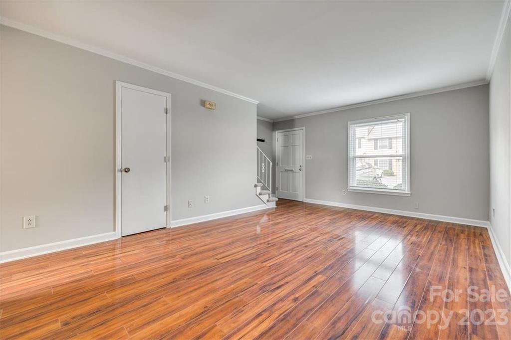 3722 Park Road, Unit I Charlotte, NC 28209 - Photo 6 of 27 an empty room with wooden floor and windows