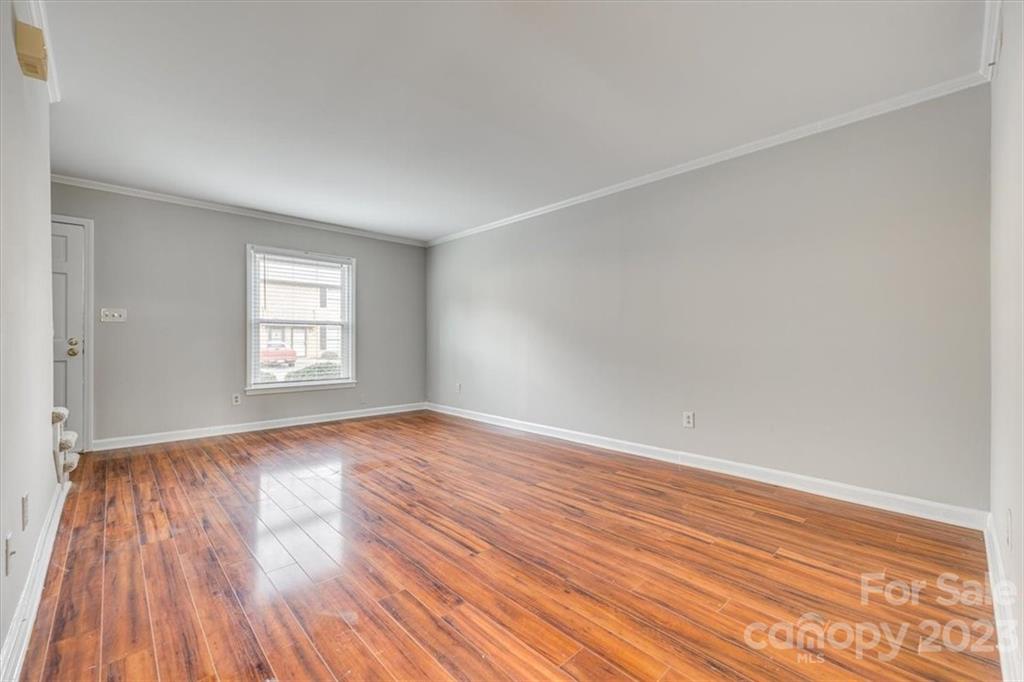 3722 Park Road, Unit I Charlotte, NC 28209 - Photo 7 of 27 an empty room with wooden floor and windows