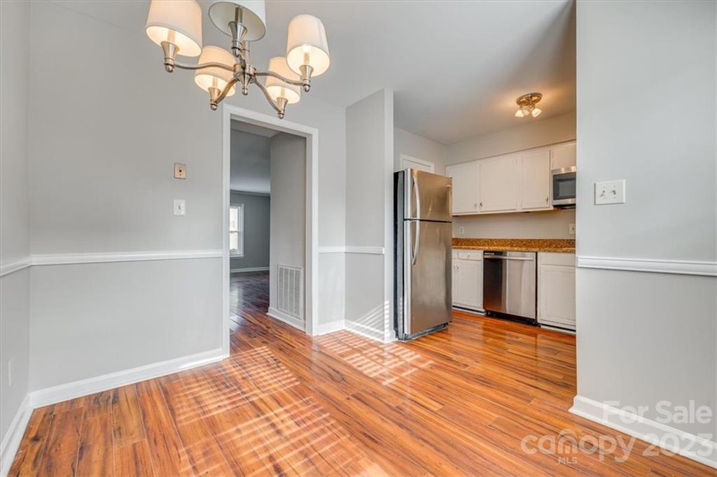 3722 Park Road, Unit I Charlotte, NC 28209 - Photo 10 of 27 a bedroom with a bed and a chandelier