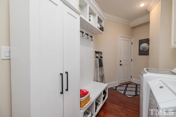 a roof deck with table and chairs under an umbrella