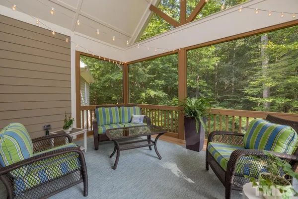 a balcony with furniture and a potted plant