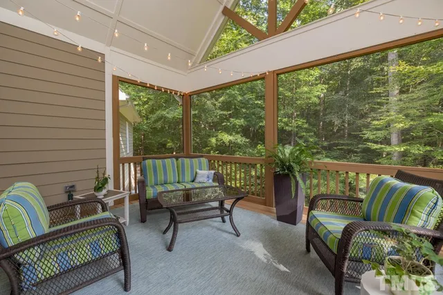 a balcony with furniture and a potted plant