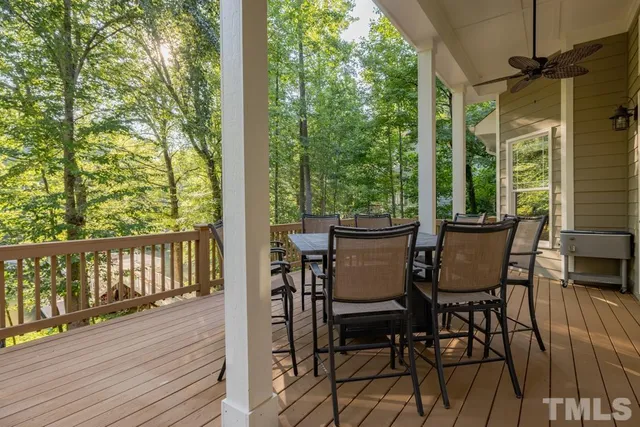 a view of a balcony with chairs and wooden floor