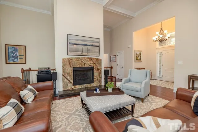 a living room with furniture a fireplace and a dining table with wooden floor