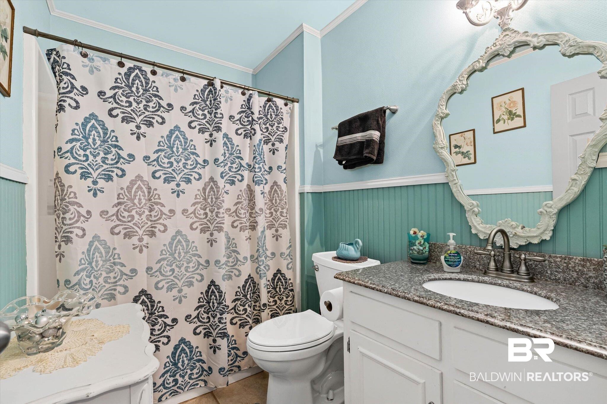 3846 Leslie Road Saraland, AL 36571 - Photo 19 of 40 Full bath featuring vanity, curtained shower, crown molding, a wainscoted wall, and light tile patterned floors