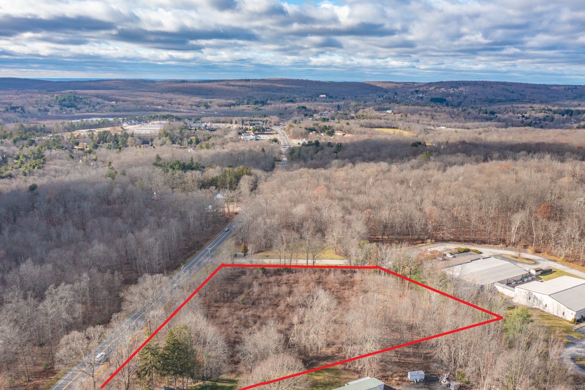 317 Merrow Road Tolland, CT 06084 - Photo 12 of 13 a view of a dry yard with a barn