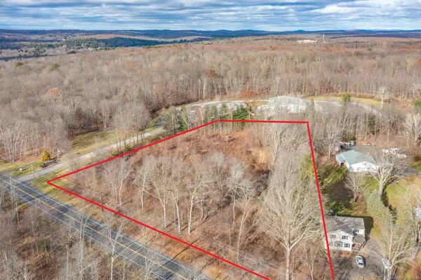 a view of a dry yard with a barn