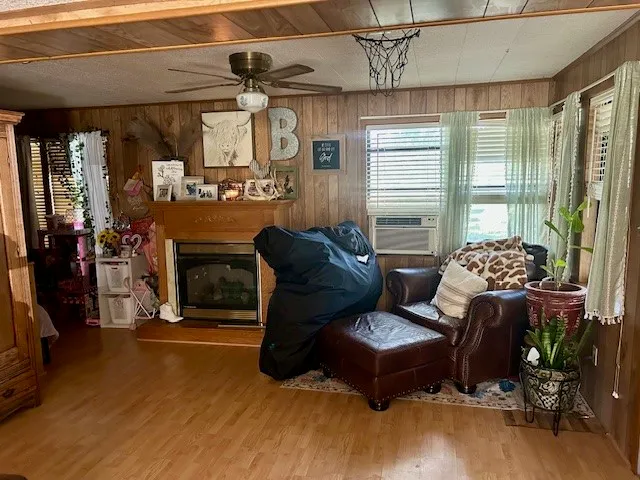 a living room with fireplace furniture and a window