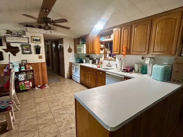 a kitchen with a sink a stove and a refrigerator