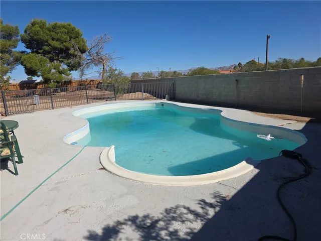 a view of a swimming pool with a lake and mountain view