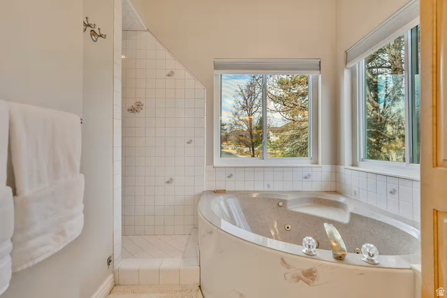 11789 Nicklaus Road Sandy, UT 84092 - Photo 41 of 58 Bathroom featuring a stall shower and a jetted tub