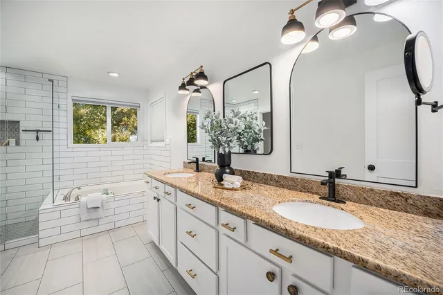 a bathroom with a granite countertop sink a large mirror and vanity