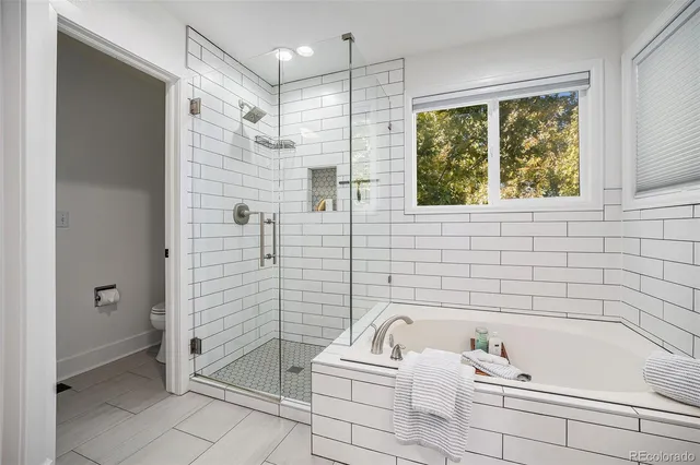a bathroom with a bathtub and shower
