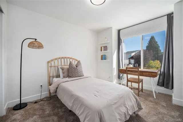 a bedroom with a bed and a table