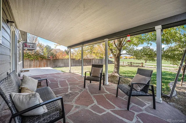 a outdoor room with chairs and a table