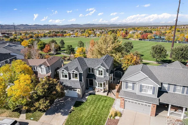 an aerial view of residential houses with outdoor space and ocean view