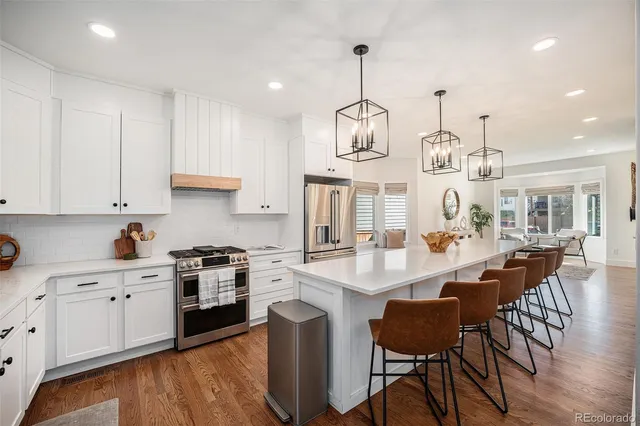 a large kitchen with a table and chairs