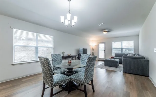 a view of a dining room with furniture wooden floor and chandelier