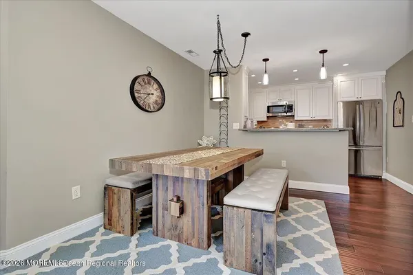 a kitchen with stainless steel appliances granite countertop a chimney a stove and a refrigerator