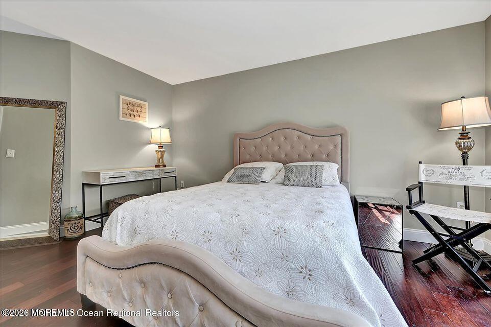 13 Racquet Road Wall, NJ 07719 - Photo 16 of 20 a bedroom with a bed and wooden floor