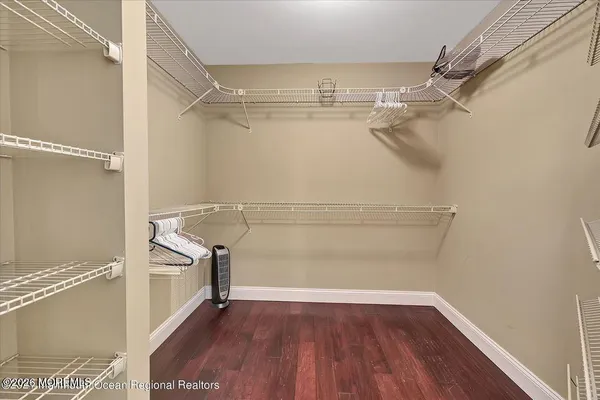 a view of walk in closet with empty racks
