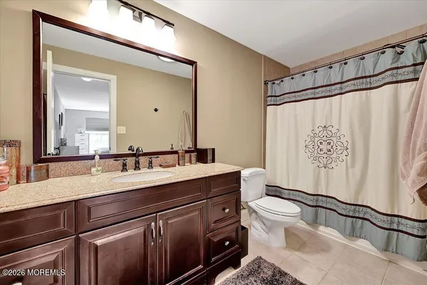 a bathroom with a sink a toilet and a mirror