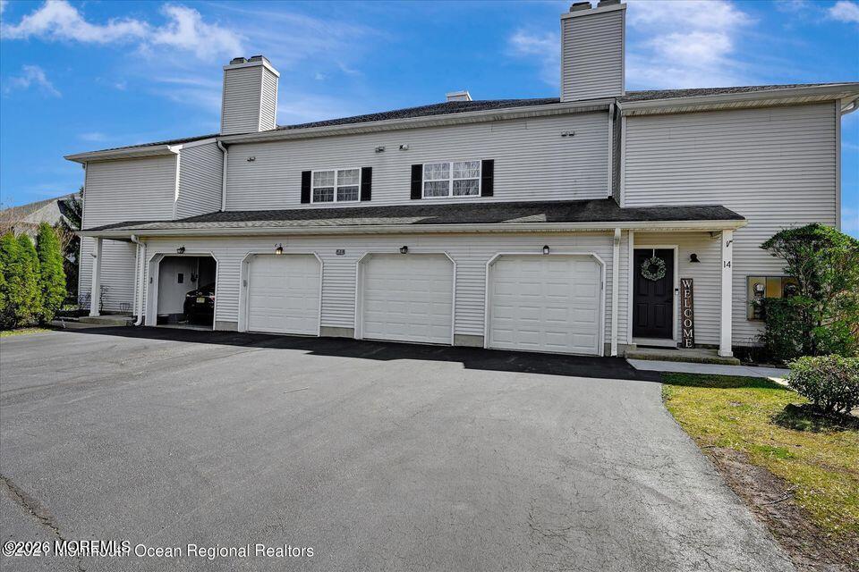 13 Racquet Road Wall, NJ 07719 - Photo 2 of 20 a front view of a house with a yard