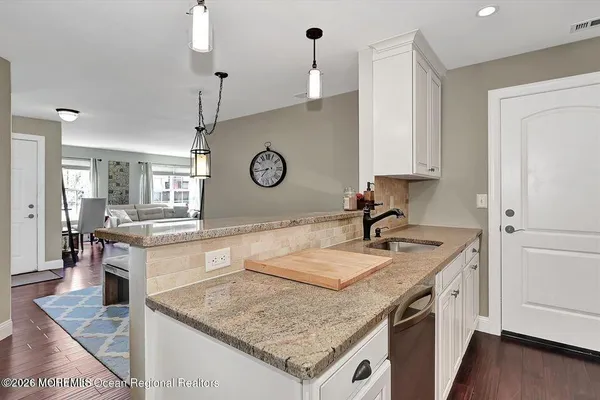 a kitchen with a stove a sink and a refrigerator