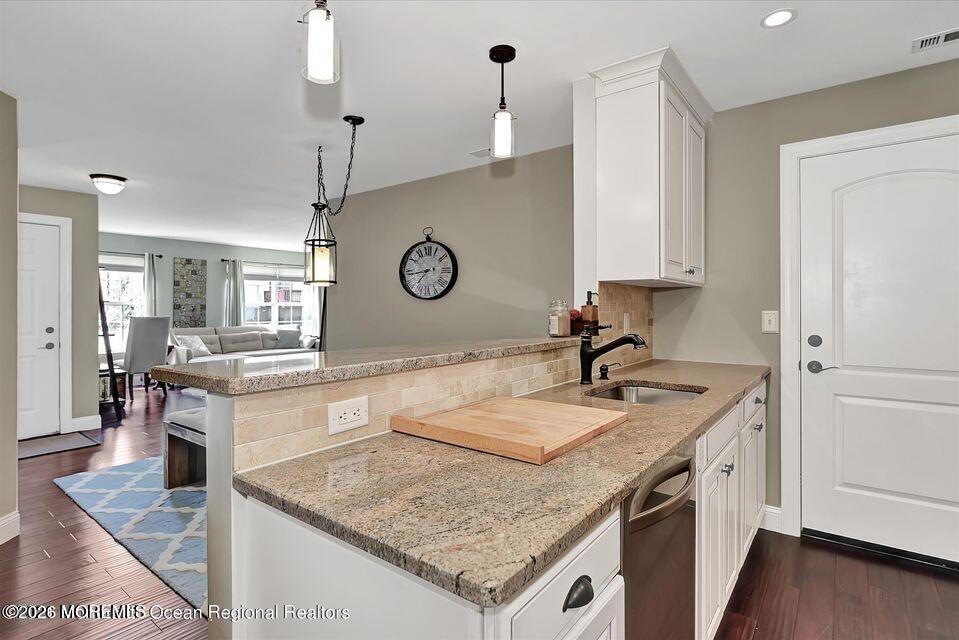 13 Racquet Road Wall, NJ 07719 - Photo 5 of 20 a kitchen with a stove a sink and a refrigerator