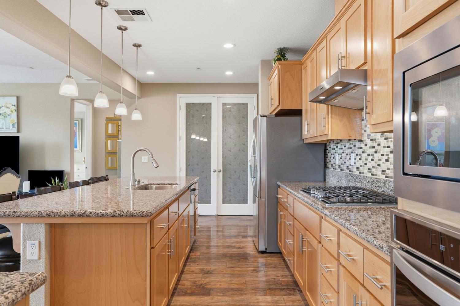 1816 Fire Power Avenue Manteca, CA 95337 - Photo 12 of 38 a kitchen with stainless steel appliances granite countertop a sink stove and cabinets