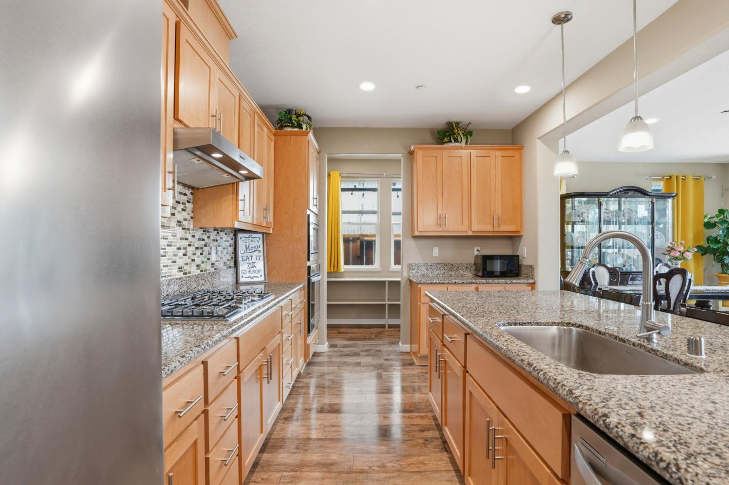 1816 Fire Power Avenue Manteca, CA 95337 - Photo 13 of 38 a kitchen with stainless steel appliances granite countertop a sink stove and cabinets