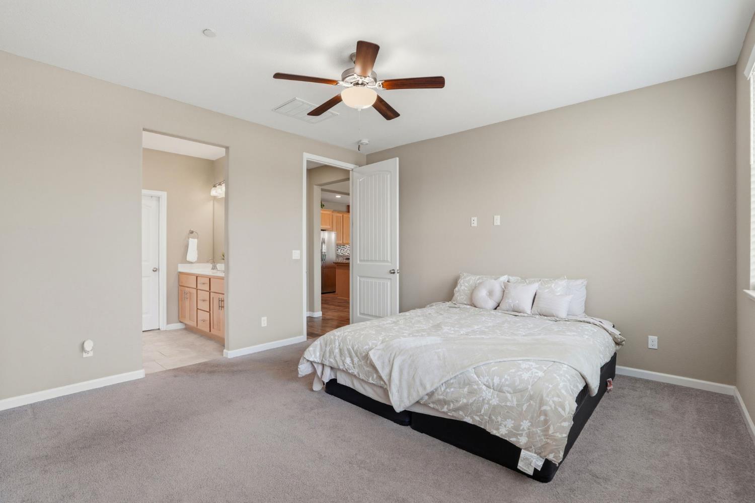1816 Fire Power Avenue Manteca, CA 95337 - Photo 20 of 38 a spacious bedroom with a bed and a ceiling fan