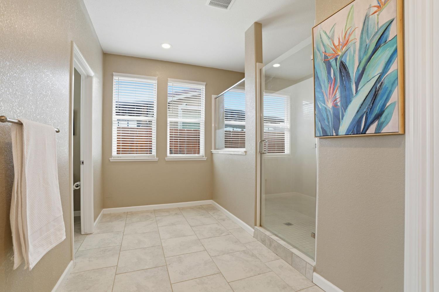 1816 Fire Power Avenue Manteca, CA 95337 - Photo 21 of 38 a view of a bathroom with a glass door shower