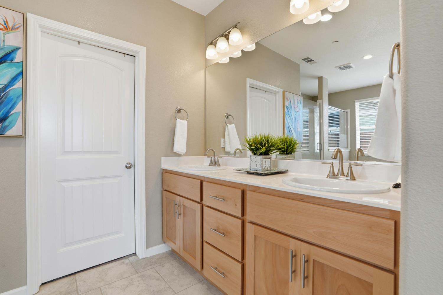 1816 Fire Power Avenue Manteca, CA 95337 - Photo 22 of 38 a bathroom with a double vanity sink and a mirror