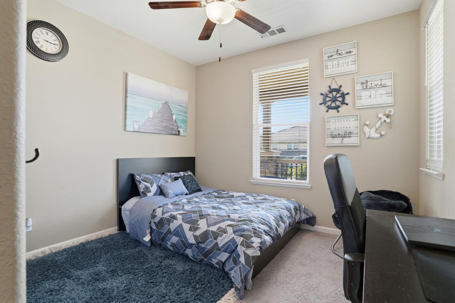 1816 Fire Power Avenue Manteca, CA 95337 - Photo 23 of 38 a bedroom with a bed a chair and a large window