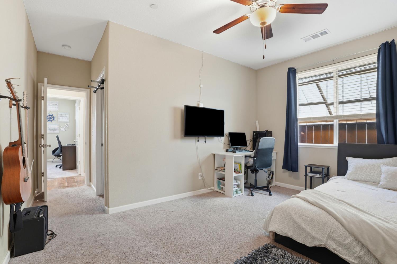 1816 Fire Power Avenue Manteca, CA 95337 - Photo 25 of 38 a bedroom with furniture and a flat screen tv