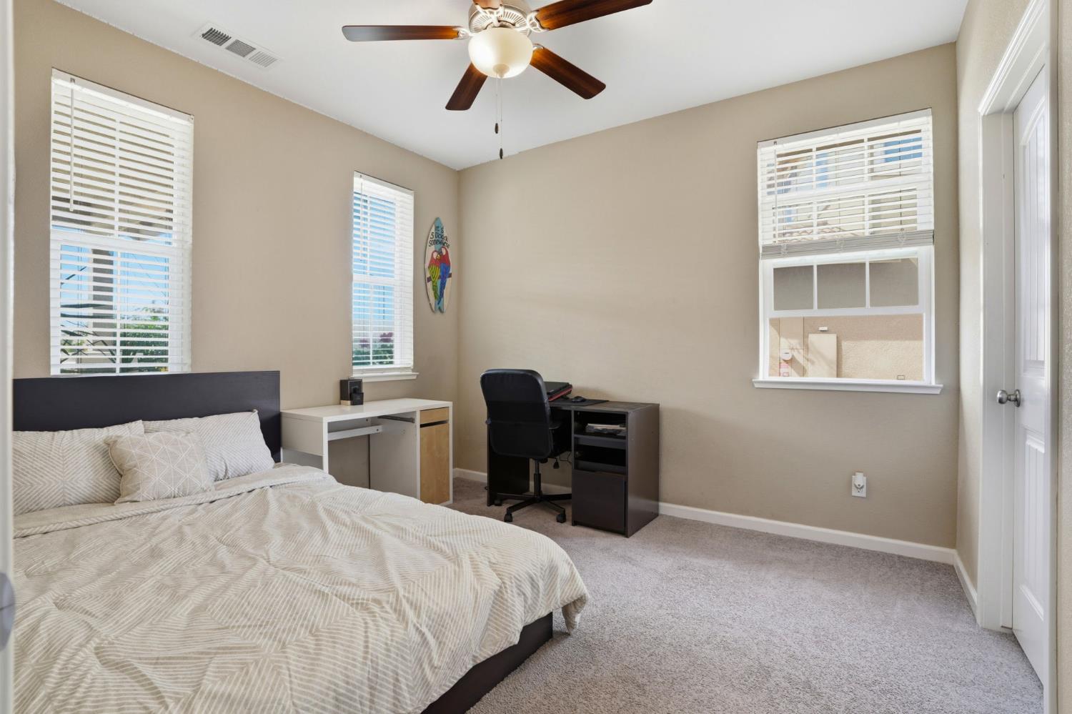 1816 Fire Power Avenue Manteca, CA 95337 - Photo 26 of 38 a bedroom with a bed and a desk