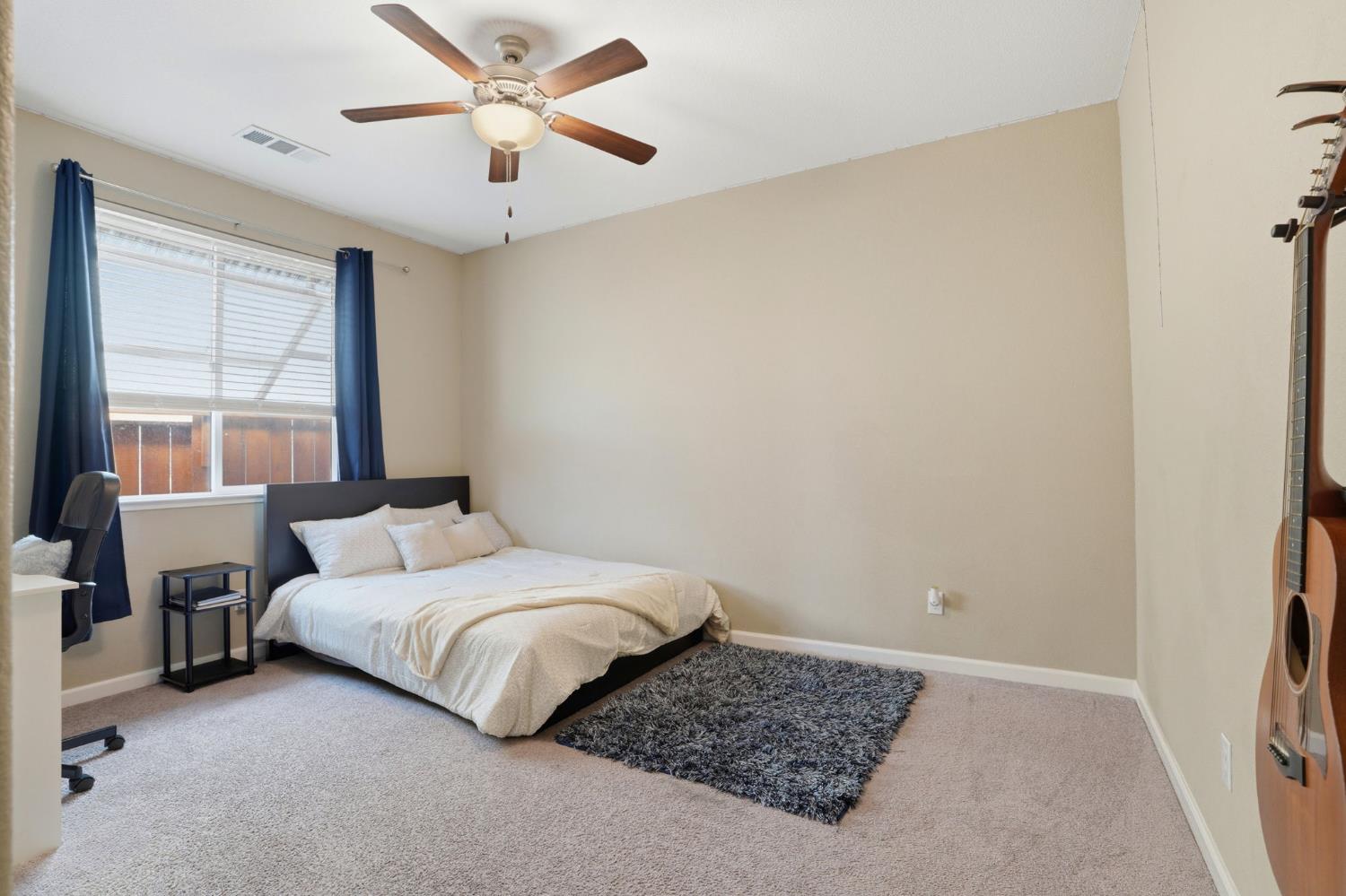 1816 Fire Power Avenue Manteca, CA 95337 - Photo 27 of 38 a bedroom with a bed and a window