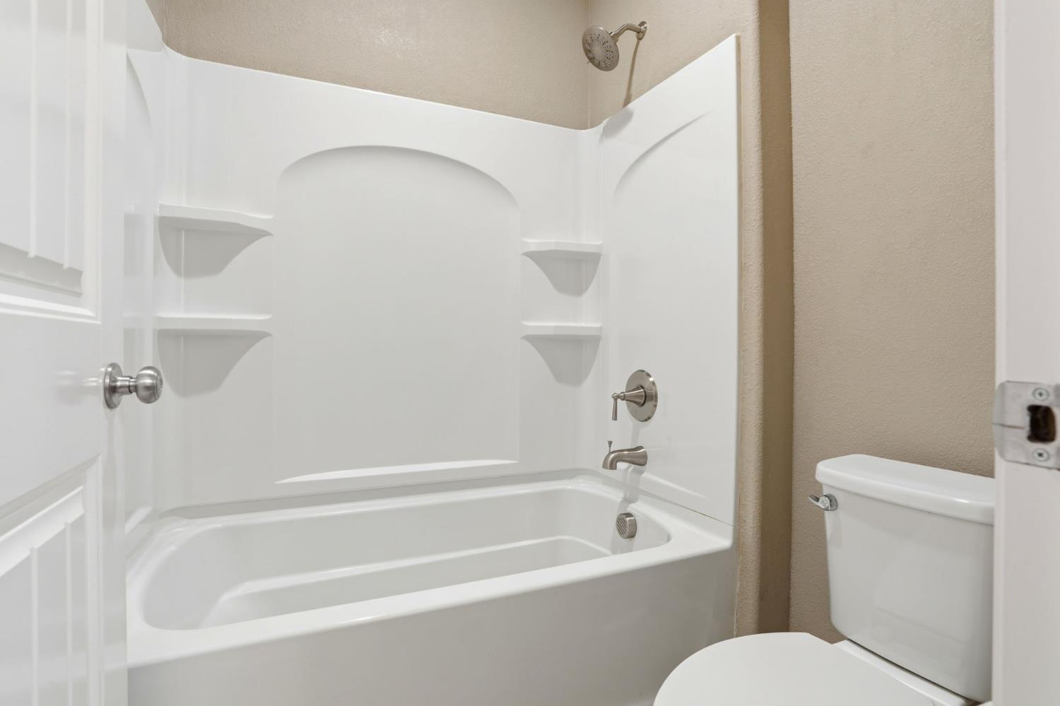 1816 Fire Power Avenue Manteca, CA 95337 - Photo 29 of 38 a bathroom with a toilet and a bathtub