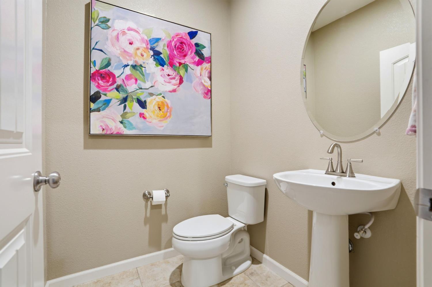 1816 Fire Power Avenue Manteca, CA 95337 - Photo 30 of 38 a bathroom with a sink and mirror with toilet