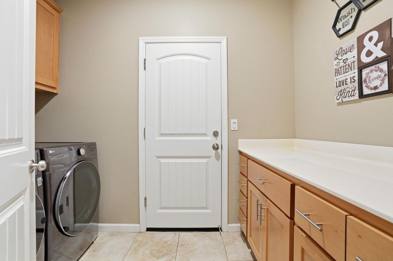 1816 Fire Power Avenue Manteca, CA 95337 - Photo 32 of 38 a view of a hallway with washer and dryer