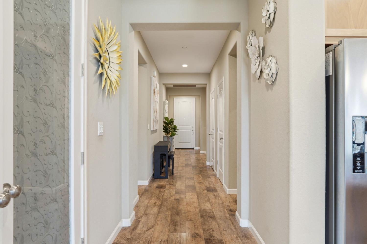1816 Fire Power Avenue Manteca, CA 95337 - Photo 9 of 38 a view of a hallway with wooden floor and a bathroom