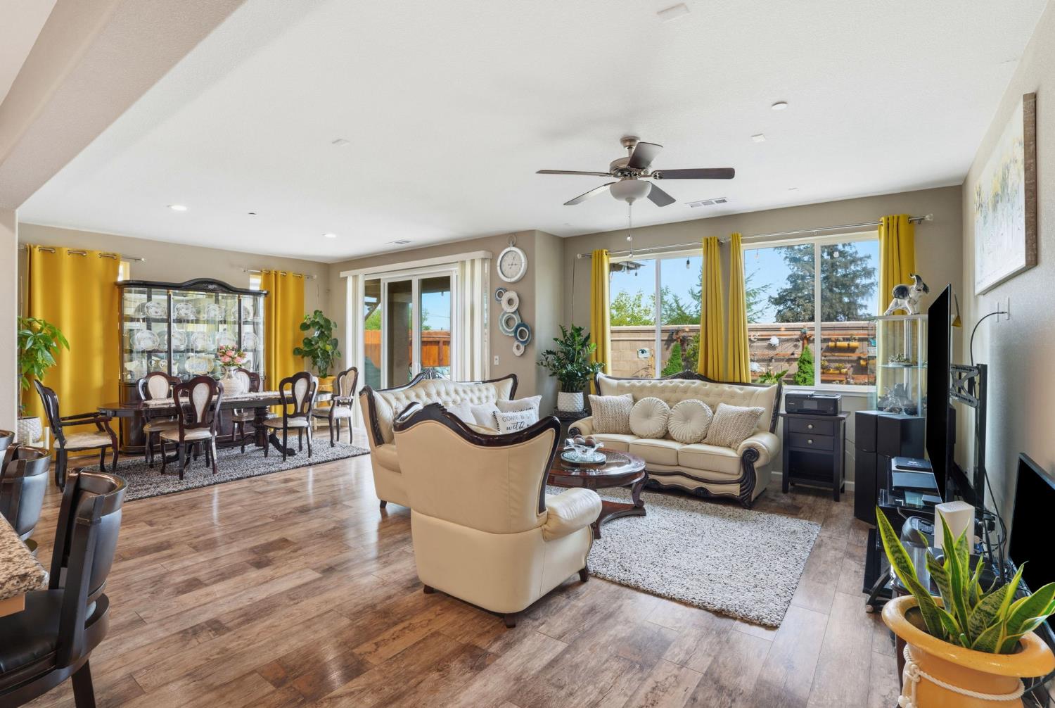 1816 Fire Power Avenue Manteca, CA 95337 - Photo 10 of 38 a living room with furniture a large window and wooden floor