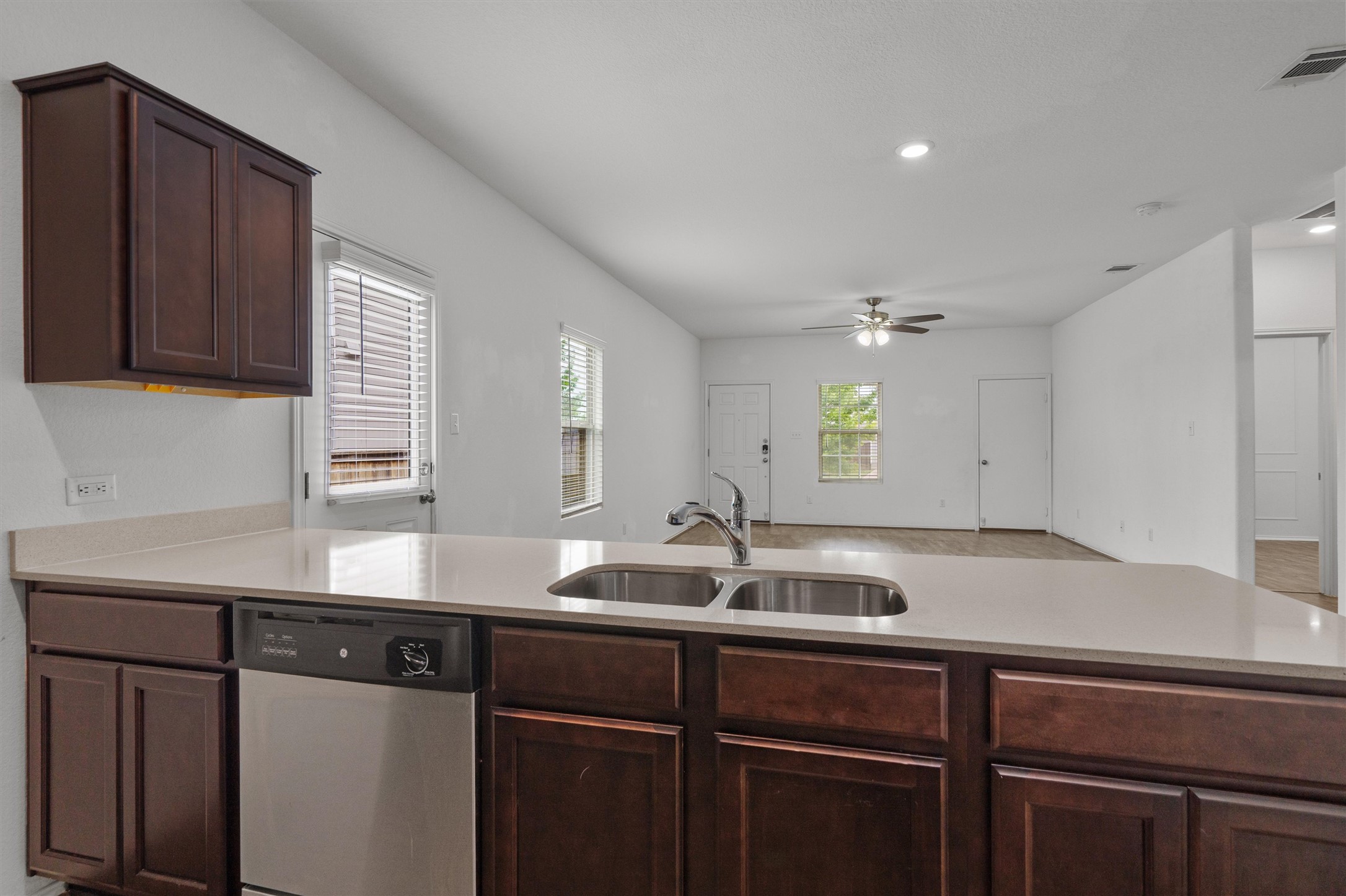 791 Circle Way Jarrell, TX 76537 - Photo 13 of 36 Kitchen island with a double basin stainless steel sink and a stainless steel dishwasher
