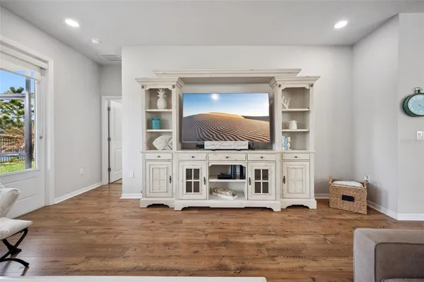 a living room with furniture large window and flat screen tv